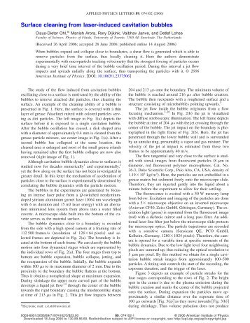 Surface cleaning from laser-induced cavitation bubbles