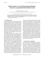 Defect modes of a two-dimensional photonic crystal in an optically ...