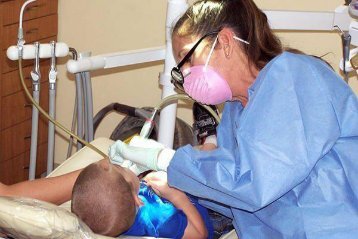 Dental hygienist at work in the laser dentistry office of Dr. Miller