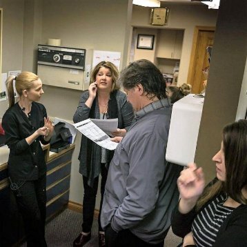 Spokane cosmetic dentist Jason Keefe DDS checking patient forms