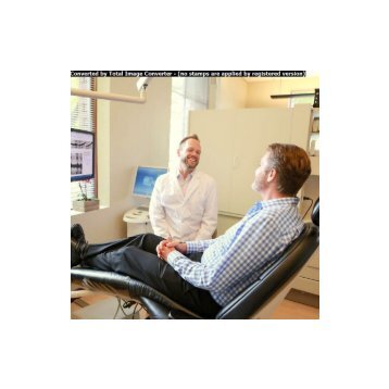 Eugene dentist Dr. Umberger chatting with dental implants patient
