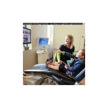 Dental Hygienist explains root canal therapy to child patient at Harmony Dental