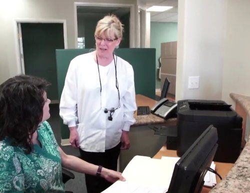 Dr Murphy talking to office manager at Temecula Ridge Dentistry, which is at 18 minutes drive to the south of Ridgestone Apartments Lake Elsinore, CA